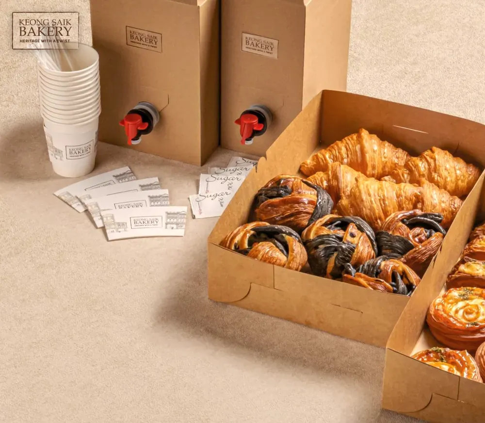 Keong Saik Bakery's office-catering page: boxes of pastries and Kopi-O dispensers photographed with the bakery's own wordmark.